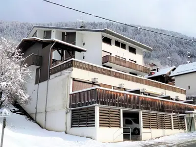 a snow covered mountain in the distance with a town at Apartment Le Sporting-3 by Interhome in Saint-Gervais-les-Bains