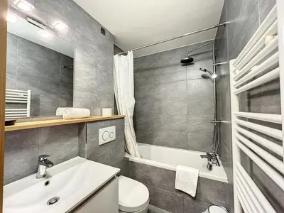 a bathroom with a sink and a toilet and a tub at Le Caribou in Chamonix-Mont-Blanc