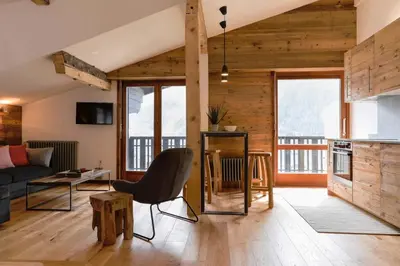 a living room with a couch and a table at Le Brevent 1 Apartment in Chamonix-Mont-Blanc