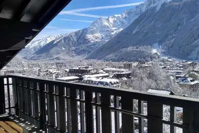 a view from the balcony of a resort with snow covered mountains at Le Brevent 1 Apartment in Chamonix-Mont-Blanc