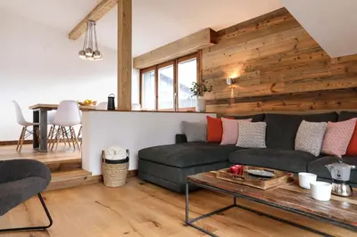 a living room with a couch and a table at Le Brevent 1 Apartment in Chamonix-Mont-Blanc
