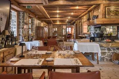 a dining room with a table and chairs at Hôtel Les Servages d'Armelle in Les Carroz d'Araches
