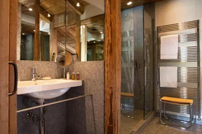 a bathroom with a sink and a glass shower at Hôtel Les Servages d'Armelle in Les Carroz d'Araches