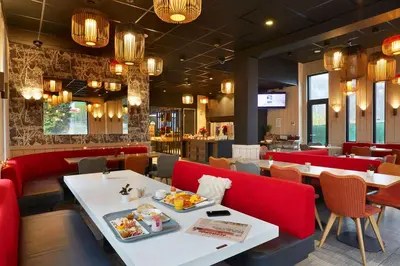 a table with two plates of food on it at Ibis Sallanches Porte du MontBlanc in Sallanches