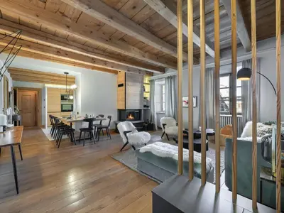 a living room with a bed and a dining room at Appartement rénové 3 ch, centre Megève, parking, wifi - FR-1-453-178 in Megève