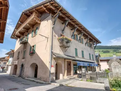 a building with a wooden roof in a street at Appartement rénové 3 ch, centre Megève, parking, wifi - FR-1-453-178 in Megève
