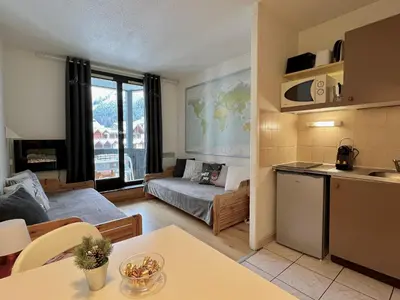 a kitchen and a living room with a couch at Le Balme Studio WiFi/Parking/Balcony in Chamonix-Mont-Blanc