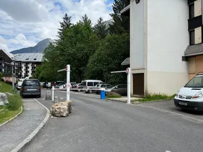 a street with cars parked in a parking lot at Le Balme Studio WiFi/Parking/Balcony in Chamonix-Mont-Blanc