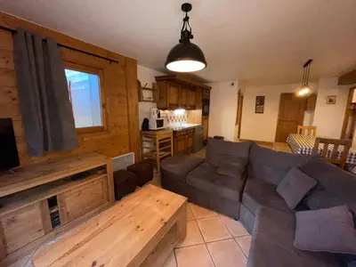 a living room with a couch and a table at Chalet Les Trappeurs in Les Carroz d'Araches