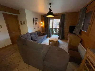 a large building with a smallshed in front of it at Chalet Les Trappeurs in Les Carroz d'Araches