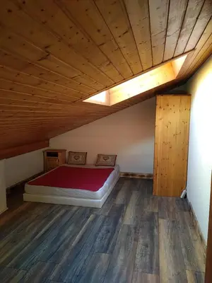 a bedroom with a bed and a wooden floor at Le Nant in Les Contamines-Montjoie