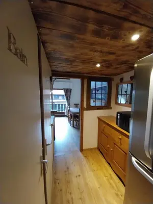 a kitchen with wooden floors and a wooden ceiling at Le Nant in Les Contamines-Montjoie