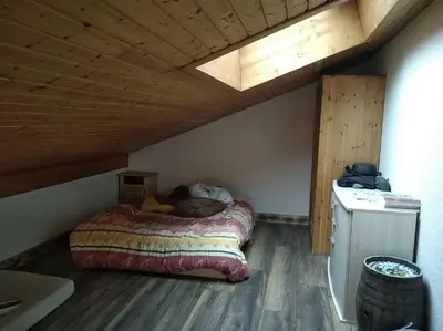 a bed in a room with a wooden ceiling at Le Nant in Les Contamines-Montjoie