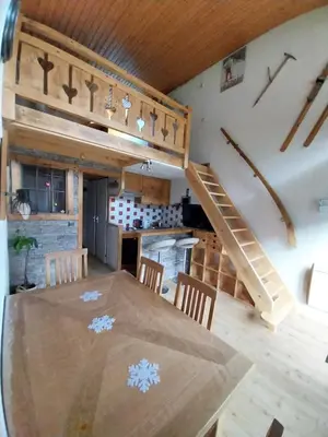 a dining room with a table and a staircase at Le Nant in Les Contamines-Montjoie
