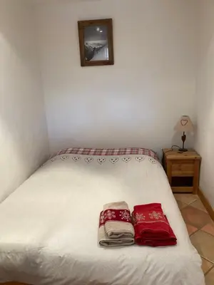 a bedroom with a bed with two towels on it at Marie Mont Blanc vue Mont Blanc in Saint-Gervais-les-Bains