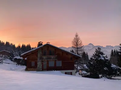 a log cabin in the snow at sunset at Marie Mont Blanc vue Mont Blanc in Saint-Gervais-les-Bains