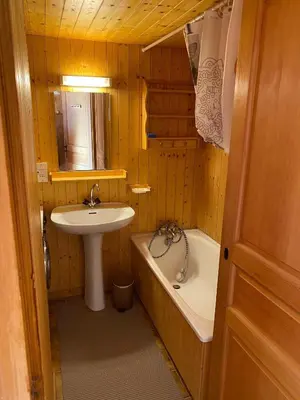 a bathroom with a sink and a bath tub and a sink at CHALET DES NEIGES in Les Carroz d'Araches