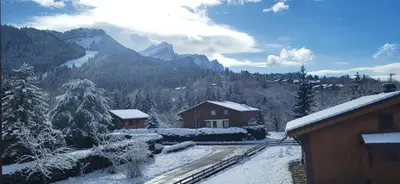 a winter view of a mountain with snow on the ground at CHALET DES NEIGES in Les Carroz d'Araches