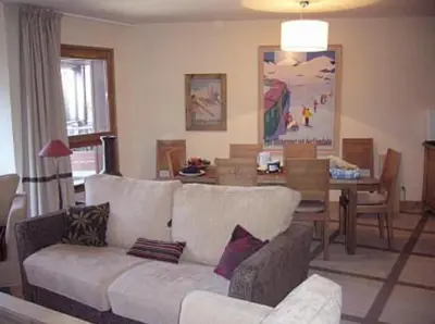 a living room with a white couch and a table at Flaine prime ski in, ski out Apartment in Flaine