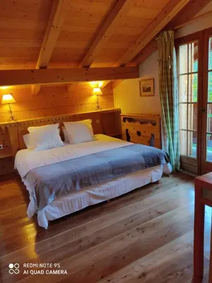a bedroom with a large bed in a wooden room at Chalet Altitude 1057 in Chamonix-Mont-Blanc