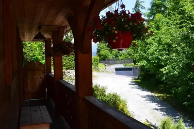a porch of a house with a hanging flower pot at Chalet Altitude 1057 in Chamonix-Mont-Blanc