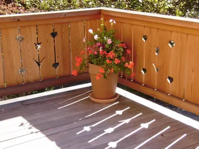 a pot of flowers sitting on a wooden deck at Chalet Altitude 1057 in Chamonix-Mont-Blanc
