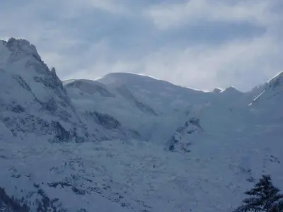 a snow covered mountain range with mountains in the background at Chalet Altitude 1057 in Chamonix-Mont-Blanc