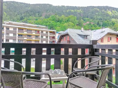 a red couch in a room with wooden walls at Apartment La Comtesse-9 by Interhome in Saint-Gervais-les-Bains