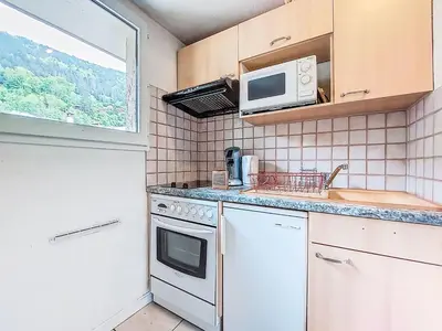 a kitchen with a stove and a microwave at Apartment La Comtesse-9 by Interhome in Saint-Gervais-les-Bains