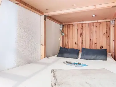 a bunk bed in a small room with a ladder at Apartment La Comtesse-9 by Interhome in Saint-Gervais-les-Bains