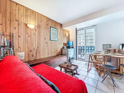 a living room with a red couch and a table at Apartment La Comtesse-9 by Interhome in Saint-Gervais-les-Bains