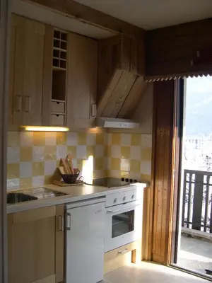 a kitchen with a sink and a stove top oven at Studio Les Drus / Studio du Brévent in Chamonix-Mont-Blanc