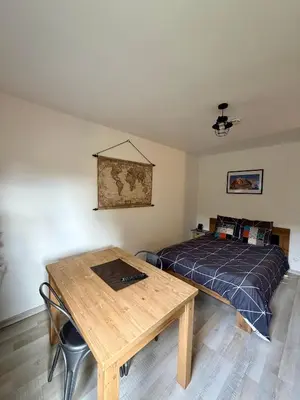 a bedroom with a bed and a wooden table at L'Ècrin Alpin in Saint-Gervais-les-Bains