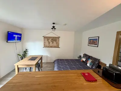 a bedroom with a bed and a table and a desk at L'Ècrin Alpin in Saint-Gervais-les-Bains