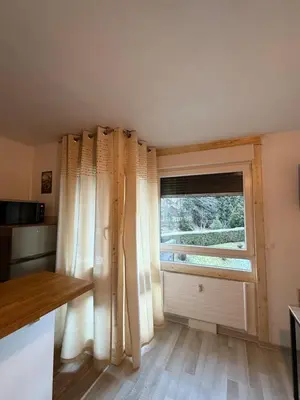 a kitchen with a window and a window blind at L'Ècrin Alpin in Saint-Gervais-les-Bains