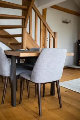 a dining room table with two chairs and a staircase at Chalet Byram in Saint-Gervais-les-Bains