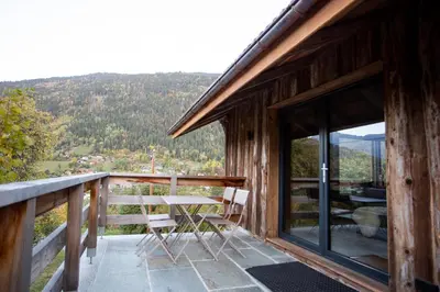 a balcony of a cabin with a table and chairs at Chalet Byram in Saint-Gervais-les-Bains