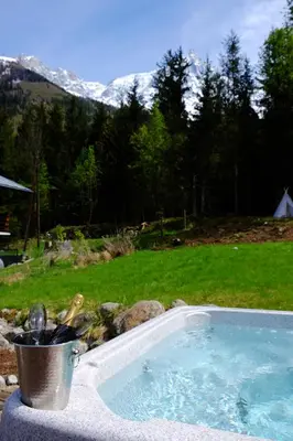 a bucket of utensils sitting next to a hot tub at Chamonix Large Chalet, Sleeps 12, 200m2, 5 Bedroom, 4 Bathroom, Garden, Jacuzzi, Sauna in Chamonix-Mont-Blanc