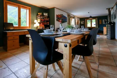 a dining room with a wooden table and black chairs at Chamonix Large Chalet, Sleeps 12, 200m2, 5 Bedroom, 4 Bathroom, Garden, Jacuzzi, Sauna in Chamonix-Mont-Blanc