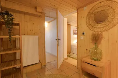 a room with a hallway with a door and a mirror at Chamonix Large Chalet, Sleeps 12, 200m2, 5 Bedroom, 4 Bathroom, Garden, Jacuzzi, Sauna in Chamonix-Mont-Blanc
