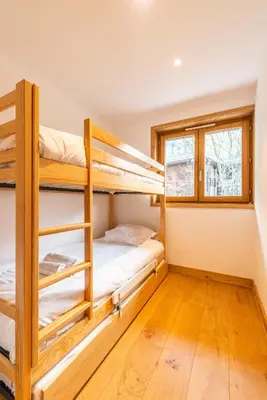 a bedroom with bunk beds in a house at Apt. Grand Paradis B14 - Modern with Mont Blanc view in Chamonix-Mont-Blanc