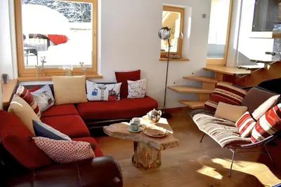 a living room with a red couch and a table at 