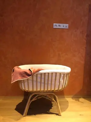 a shopping basket with a hat on top of it at 
