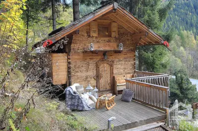 a log cabin with a porch and a wooden deck at 