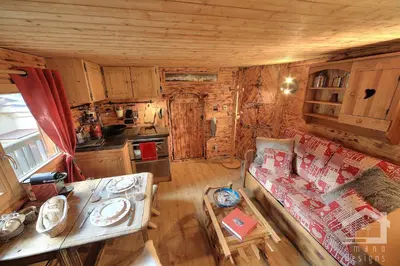 an overhead view of a living room and kitchen in a log cabin at 