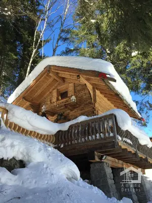 a log cabin with a snow covered roof at 