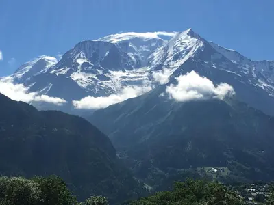 a snow covered mountain with a town in front of it at Chalet du Meilly in Saint-Gervais-les-Bains