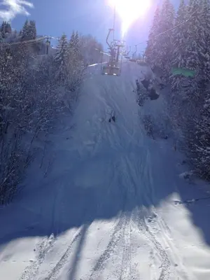 a snow covered ski slope with a ski lift at Chalet du Meilly in Saint-Gervais-les-Bains