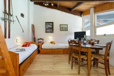 a bedroom with a table and a bed and a desk at Résidence Grand Roc - Bruyères 441 - Happy Rentals in Chamonix-Mont-Blanc