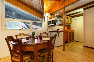 a kitchen and dining room with a table and chairs at Résidence Grand Roc - Bruyères 441 - Happy Rentals in Chamonix-Mont-Blanc